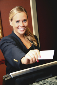 A beautiful Concierge holding a card