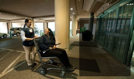 A person moving a patient politely